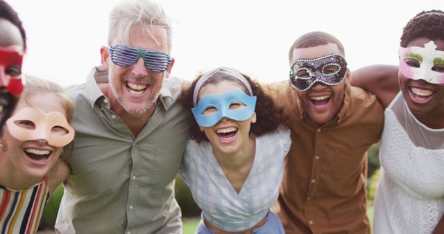 Joyful Friends in Colorful Masks Celebrating Outdoors - Download Free Stock Images Pikwizard.com