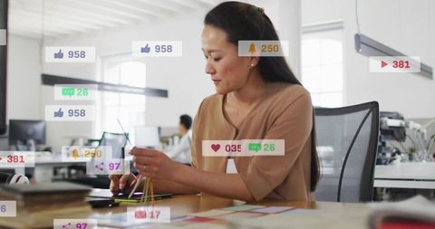 Designer sorting color swatches while tapping tablet with social media notifications overlay