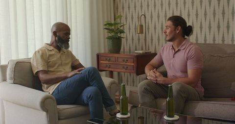 Men Socializing in Cozy Living Room Setting with Drinks