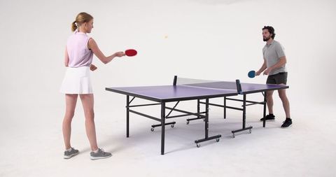 Couple in Sportswear Playing Table Tennis Indoors