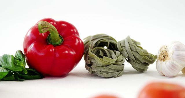 Close-up of Fresh Bell Pepper, Green Pasta, Garlic and Basil - Download Free Stock Images Pikwizard.com