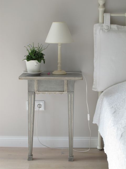 Rustic Nightstand with Lamp and Plant in Cozy Bedroom - Download Free Stock Photos Pikwizard.com