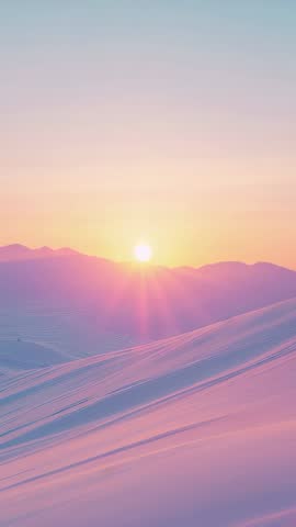 Sun rising over pastel snowfields, alpine ridge casting warm dawn rays in vertical video
