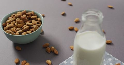 Almonds in Bowl with Glass of Almond Milk on Grey Background - Download Free Stock Images Pikwizard.com