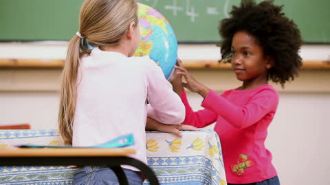 Children Exploring World Map on Globe in Classroom