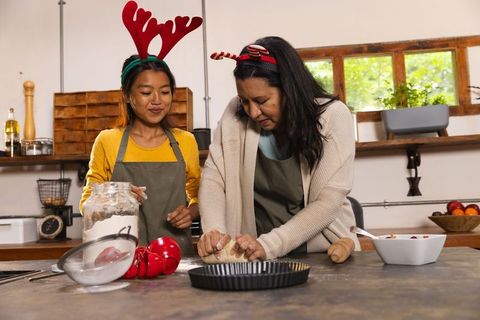Friends Baking Together in Rustic Kitchen with Festive Headwear