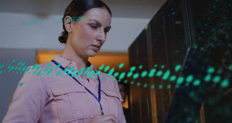 Caucasian Female IT Professional Analyzing Data in Server Room