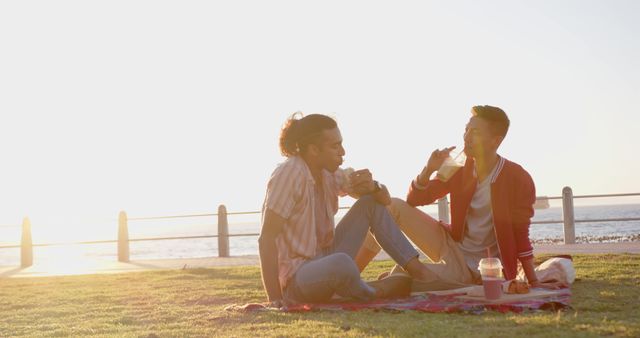 Young Diverse Friends Enjoying Picnic by the Beach at Sunset - Download Free Stock Images Pikwizard.com