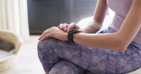 Middle-aged Woman Checking Smartwatch for Fitness Update