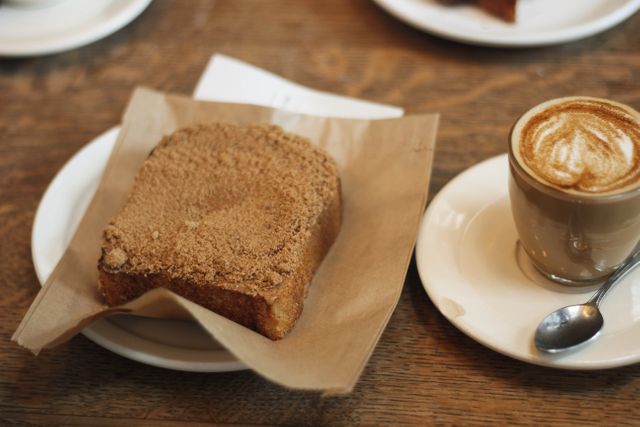 Delicious Slice of Coffee Cake with Cup of Cappuccino on Wooden Table - Download Free Stock Photos Pikwizard.com