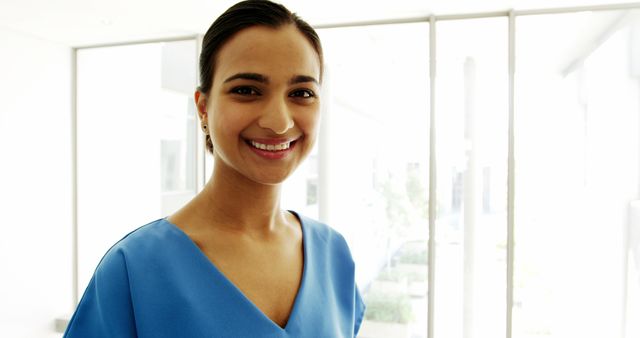 Smiling Professional Woman in Bright Office Environment - Download Free Stock Images Pikwizard.com