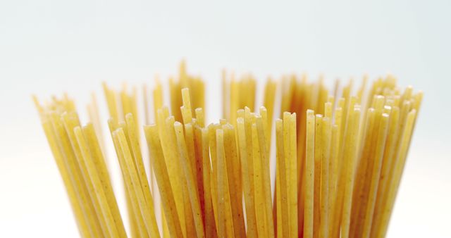 Close-up of Uncooked Spaghetti Sticks Against White Background - Download Free Stock Images Pikwizard.com