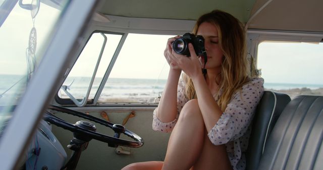 Young Woman Taking Photos on Beach from Camper Van Interior - Download Free Stock Images Pikwizard.com