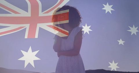 Serene woman in white dress overlaid with australian flag