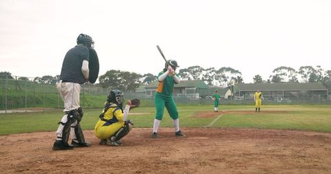 Female Softball Batter Ready to Swing on Community Field