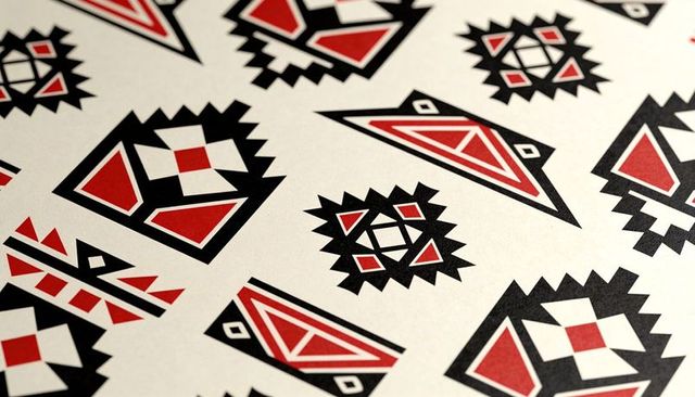 Bold geometric red and black tribal pattern on printed sheet for textile design