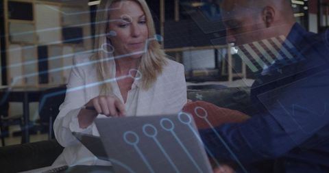 Colleagues Reviewing Data with Digital Technology Overlay in Office