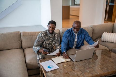 Father and Son Discussing Documents at Home