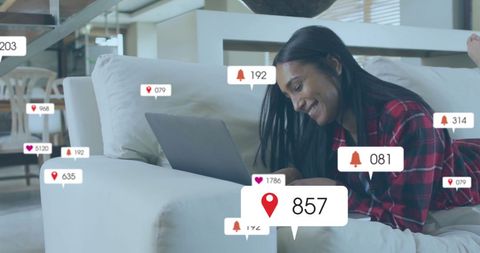 Woman Engaged with Social Media on Laptop with Interaction Icons