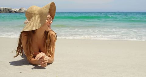 Woman Relaxing on Sandy Beach with Sun Hat and Sunglasses - Download Free Stock Images Pikwizard.com