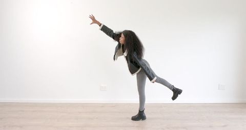 Young Woman Expressing Confidence in Minimalist Setting