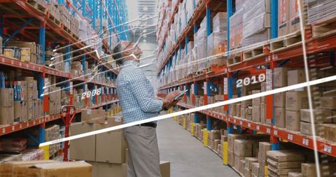 Warehouse Worker Using Tablet for Digital Inventory Management