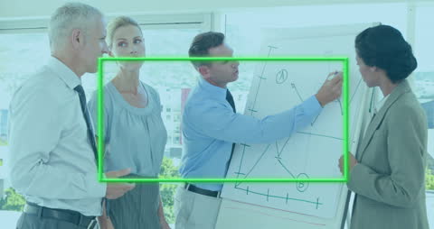 Diverse Business Team Analyzing Graph Data in Office Meeting