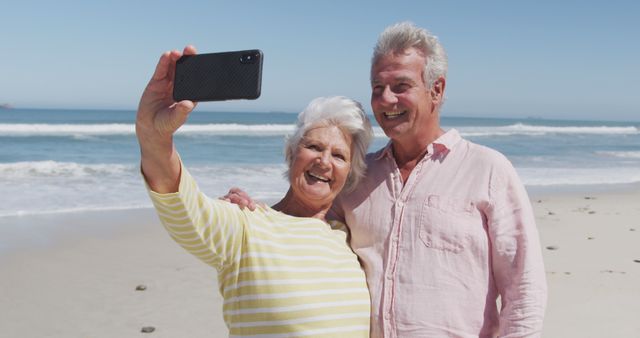 Senior Couple Taking Selfie on Beach During Sunny Day - Download Free Stock Images Pikwizard.com