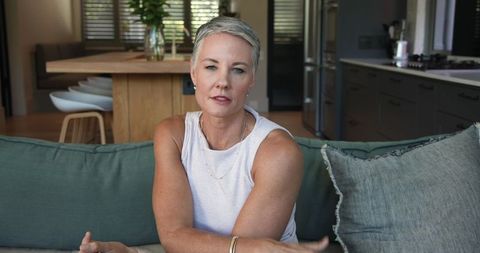 Mature Woman Relaxing in Stylish Open-Plan Living Room