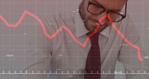 Businessman analyzing decreasing financial chart trends