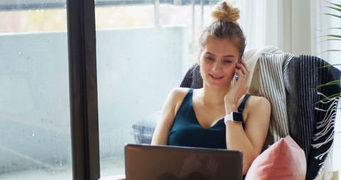 Woman Uses Laptop While Talking on Phone at Home - Download Free Stock Images Pikwizard.com
