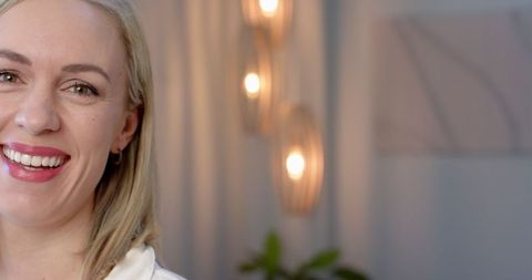 Smiling Woman in Modern Room with Innovative Lighting Design