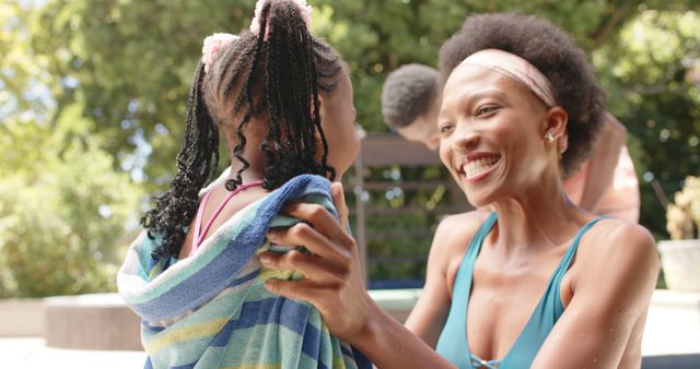 Mother drying daughter with towel outdoors - Download Free Stock Images Pikwizard.com