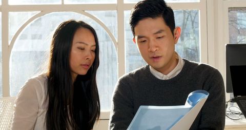 Business Executives Collaborating in Sunlit Office