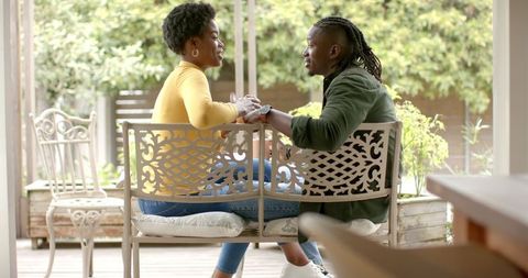Couple Holding Hands, Sharing Intimate Moment on Deck