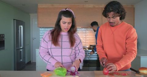 Friends Preparing Fresh Salad on Kitchen Island, Chopping Tomatoes Onions Lettuce