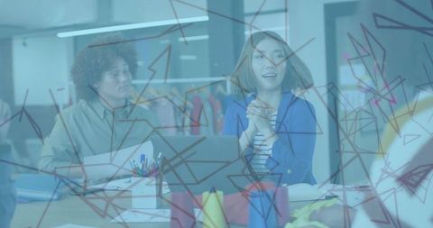 Team of designers discussing creative project in modern studio