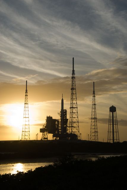 CAPE CANAVERAL, Fla. - As the sun sets behind Launch Complex 39B at NASA's Kennedy Space Center in Florida, the Ares I-X rocket awaits the approaching liftoff of its flight test.    This is the first time since the Apollo Program's Saturn rockets were retired that a vehicle other than the space shuttle has occupied the pad.   Part of the Constellation Program, the Ares I-X is the test vehicle for the Ares I.  The Ares I-X flight test is set for Oct. 27.  For information on the Ares I-X vehicle and flight test, visit http://www.nasa.gov/aresIX. Photo credit: NASA/Kim Shiflett