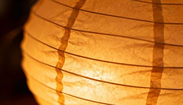 Warm Paper Lantern Close-Up Showing Translucent Texture, Ribbed Frame and Seam Details