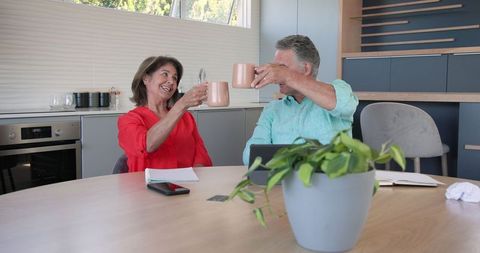 Senior Couple Enjoying Quality Time with Coffee in Modern Kitchen