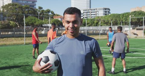 Young male athletes practicing soccer on sunny day