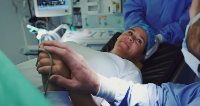 Close--up of Caucasian man comforting pregnant woman during labor in operation theater - Download Free Stock Photos Pikwizard.com