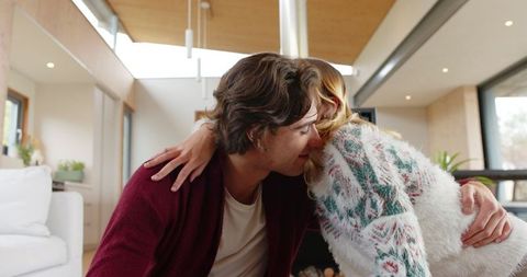 Friends Embracing in Modern Living Room with Warm Interiors