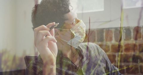 Masked Professional Contemplating Ideas in Office Environment