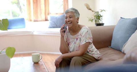 Happy Senior Woman Talking on Smartphone at Home