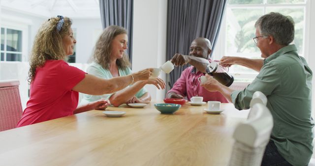 Group of Friends Enjoying Coffee Together at a Dining Table - Download Free Stock Images Pikwizard.com