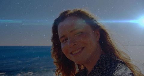 Smiling Woman Enjoying Sunny Ocean View on Sandy Beach