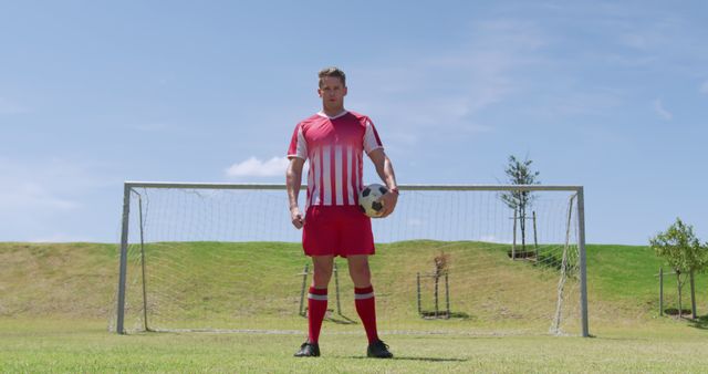 Soccer Player Standing with Ball in Front of Goal on Sunny Day - Download Free Stock Images Pikwizard.com