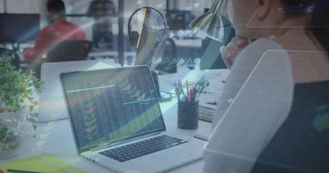 Businesswoman Analyzing Financial Data on Laptop at Office