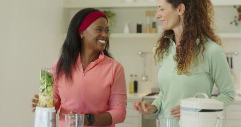 Diverse Friends Preparing Healthy Fruit Drink with Blender